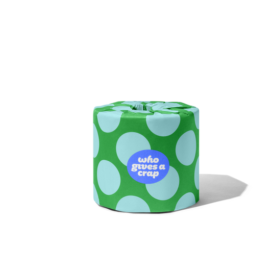 Singular toilet paper roll in a polka dot wrapper