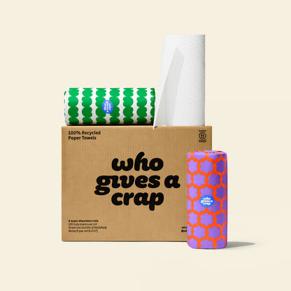 Box of six Who Gives a Crap paper towel with two rolls wrapped in colourful packaging sitting on top.