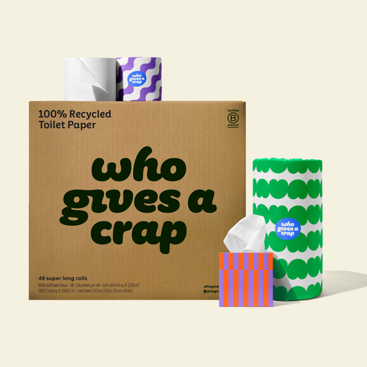 Two rolls and a box of Who Gives a Crap compostable rubbish bags with green packaging